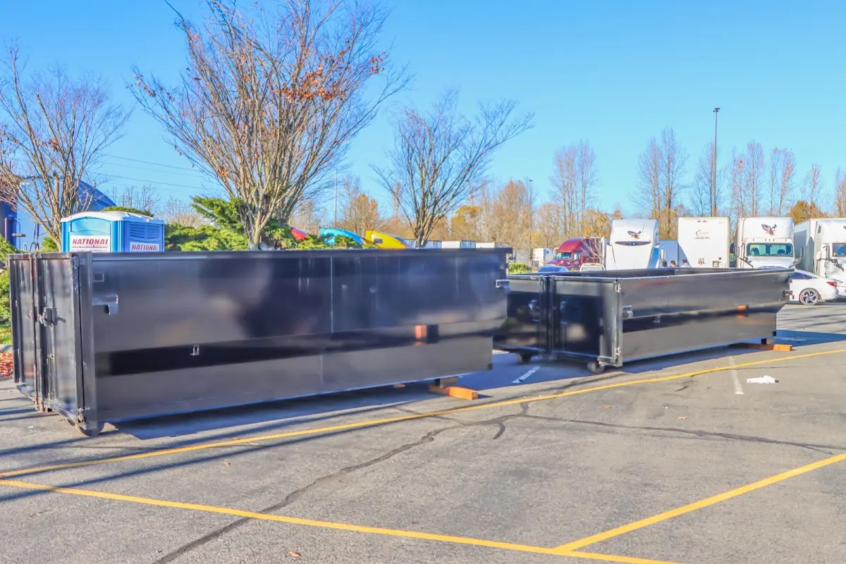 Professional dumpster rental service with roll-off container on residential driveway in North Haven